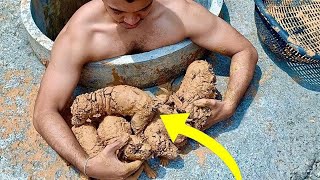 man sees something in the mud takes a closer look and realizes what it is