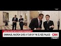 emmanuel macron shows richard quest the artwork on display at the Élysée palace