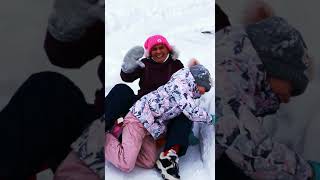 Alena and mom go down the hill on the ice