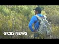 CBS News joins volunteers searching for missing migrants on dangerous path