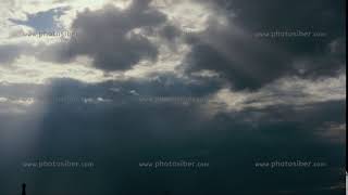 The sun's rays shine through the clouds