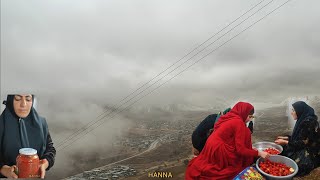 The art of a nomadic woman making tomato paste in heavy rain and fog