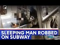 Video shows subway robber cutting hole in sleeping man's pants, robbing him