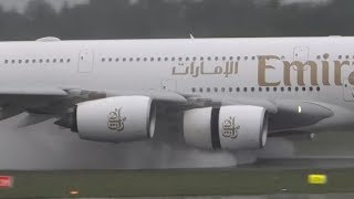 Heavy rain plane spotting with water blast and reverse thrust spray on landing A380 Hamburg airport