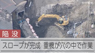 道路陥没現場にスロープが完成　重機が穴の中へ