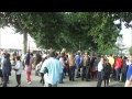 walking amongst crowds of people along the south bank of the river thames on a warm summer s day.