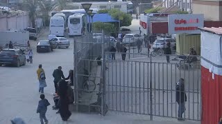 People gather in front of Nasser hospital as wounded Gazans prepare to leave for treatment