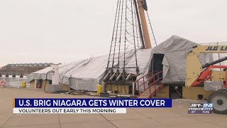 Volunteers help place winter cover over U.S. Brig Niagara