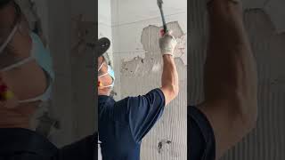 Demolishing tile during a bathroom renovation