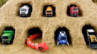 Toy construction truck sand house in trouble because of strange snakes