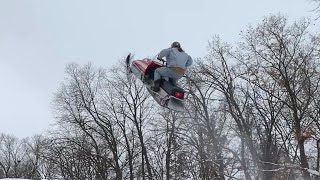 Larry Enticer Jumps Over Bus On Snowmobile