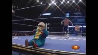 Wrestler drop kicks midget in a monkey suit.