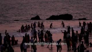 Tourists cluster on shore of Rama Krishna Beach in Andhra Pradesh