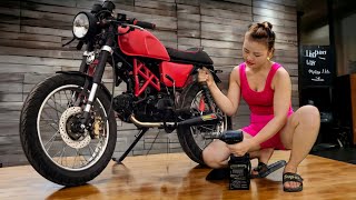 The genius mechanic girl has perfectly modified the Win100 motorbike at her shop