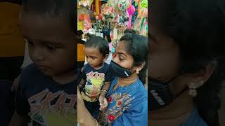 Naksh enjoying toys at THUMBUR Ayyappankavu Ulsavam 12/22.