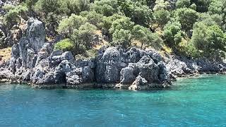 Gocek 12 islands day cruise: passing by Tersane Cove and reaching Crystal Cove on Tersane Island.