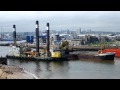 liebherr p995 loading up the long sand barge as the f.d. incomparable passes