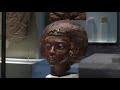 portrait head of queen tiye with a crown of two feathers