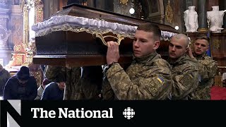 Ukrainians mourn fallen soldiers after a month of war