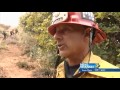 hand crews building containment lines in hard to reach areas