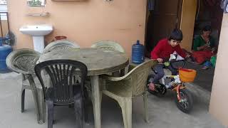 Ishani Dahal riding bicycle at home.