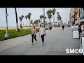 solo cleanup at venice beach restrooms as police officers stand by