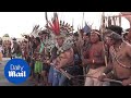 Amazonian protesters launch arrows at Brazilian police in land dispute - Daily Mail