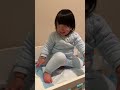 cute 2 year old little girl climbs changing table on her own