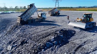 EP09!Project activities,pouring rocks into the muddy water in the large lake using 25-ton excavator