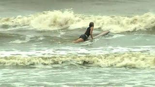 Surfers take advantage of churning seas in Galveston