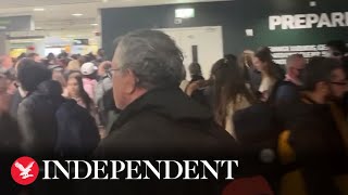 Passengers wait in long queues at Dublin Airport amid security chaos