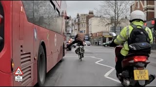 Red light jumping Silly Cyclist gives a bus the boot