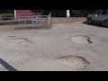 Massive potholes in parking lot of SW Houston post office endangering senior community