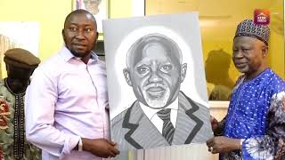 Artist Lamin Jobe Presents a Portrait to Hon. Ousainou Darboe