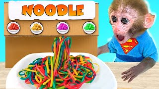 Monkey baby Bon Bon eats colorful pasta and swims with the puppy in the pool