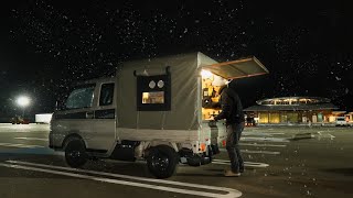 Sleeping in a light truck on a snowy roadside