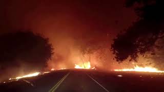 Wildfires rage around California road