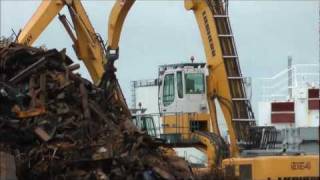 Liebherr 954 excavator loading ship with scrap metal