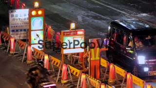 Long panning shot of traffic diversions and cars.  Scenes...