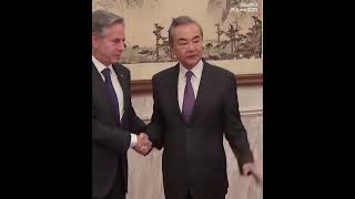 China's top diplomat Wang Yi shaking hands with US Blinken as closed-door meeting starts