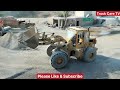 caterpillar 950c wheel loader loading stone crushed on dumper truck