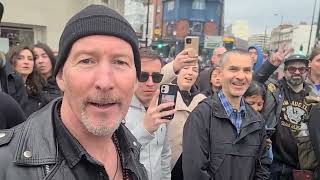 "Bono & the Edge" invited to sing with street buskers in London.  Or are they tribute artists?