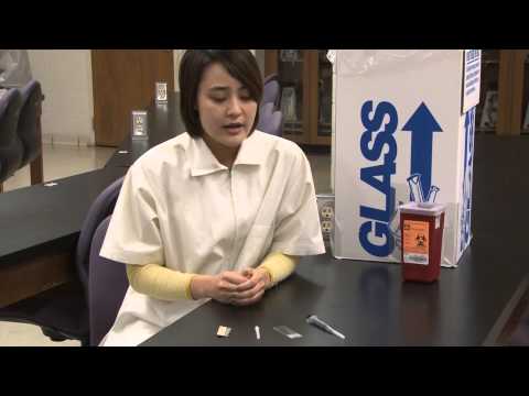 What is the most appropriate location for disposal of contaminated sharps?