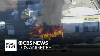 Fire spreads to two cars, commercial structure in downtown LA's Fashion District