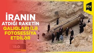 İsrailli vətəndaşlar İranın atdığı raketin qalıqları ilə şəkil çəkdirirlər