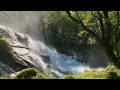 waterfall on mountainside sun rays and mist