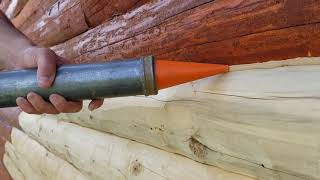 Log Master's Apprentice Philemon Applying Sashco Conceal Caulk Bead to Log Joinery