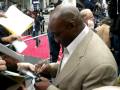 Michael Clarke Duncan signing photo for fans at the premier of prince of persia.