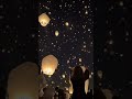 People Releasing Lanterns to the Sky During Sky Lantern Celebration