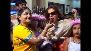 Dimple Kapadia has cake stuffed in mouth, politely eats slice: What's with the dark shades indoors?